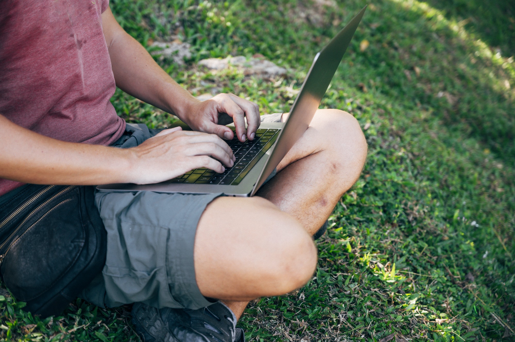 Digital nomad man working in the forest